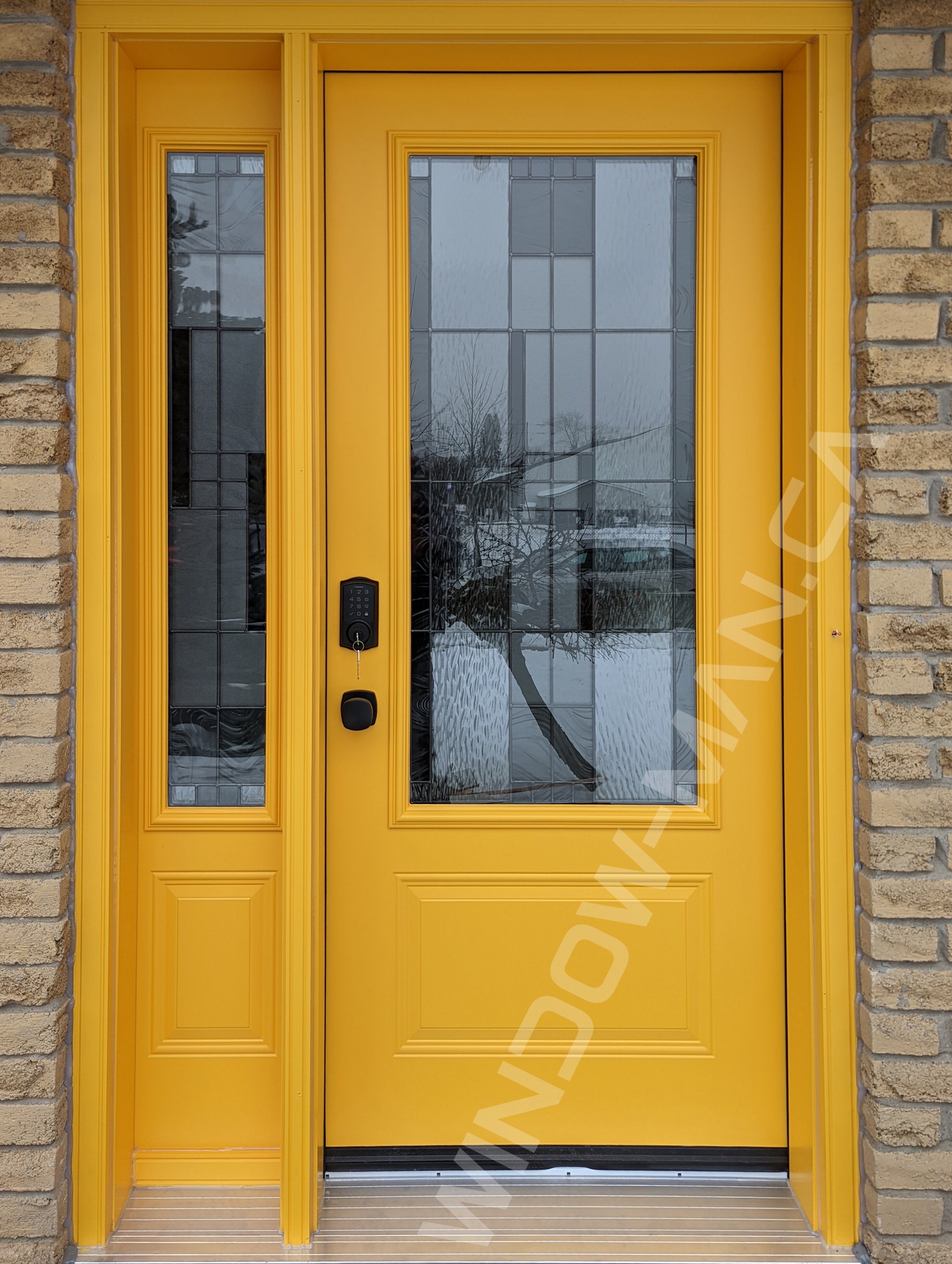 yellow steel door with sidelight and 3/4 santa fe stained glass, smart lock