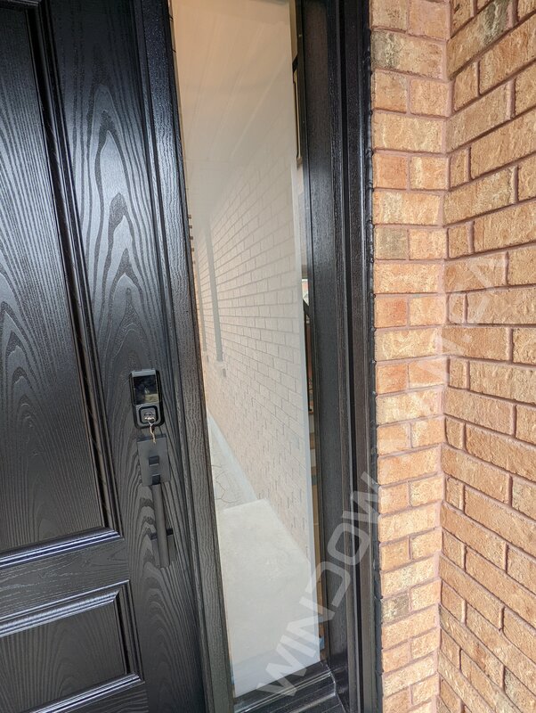 black fiberglass door with sidelight and clear border glass, wide sidelight, smart lock - detailed close up