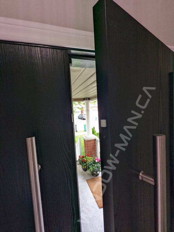 black oak grain fiberglass double door with acid etched glass and pull bar handles - detailed close up