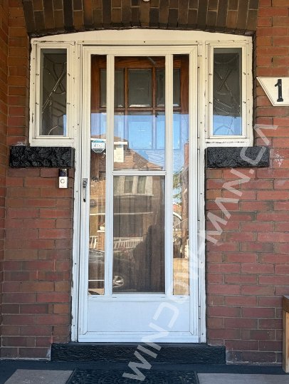 black steel craftsman door with side windows and santa fe stained glass, 2 panel - before-after