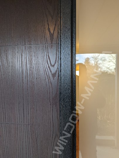 brown oak grain fiberglass door with sidelights and clear border glass, groove design, multipoint lock - detailed close up