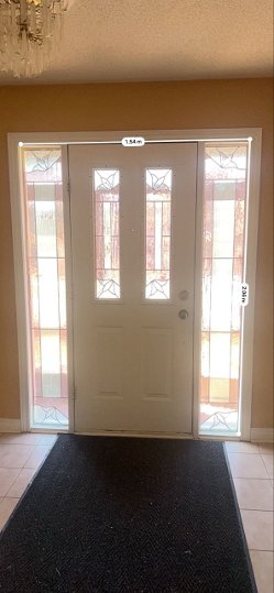 front double door in white with forest king full wrought iron glass lions - before-after